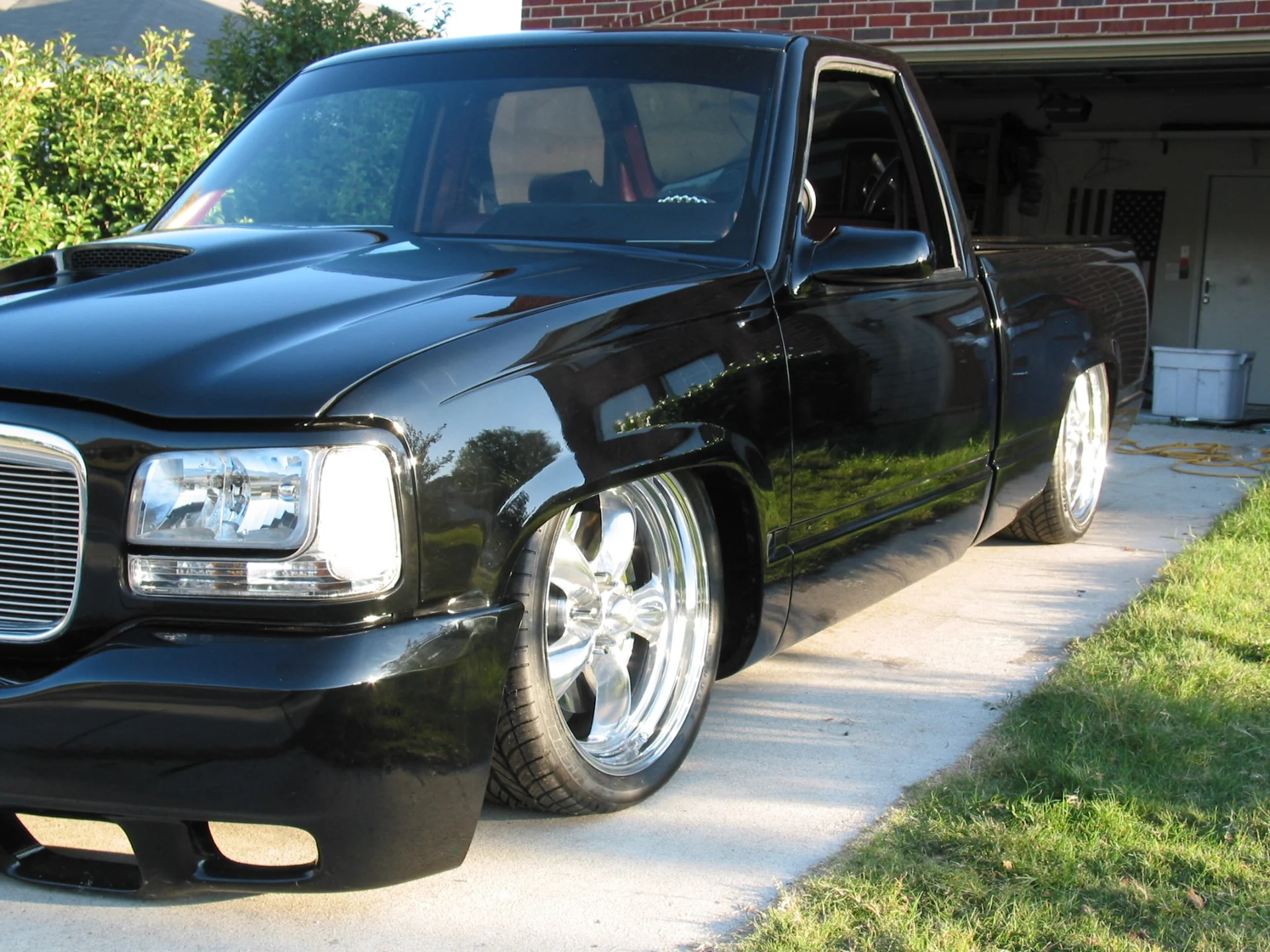 Black OBS truck and polished wheels in the driveway