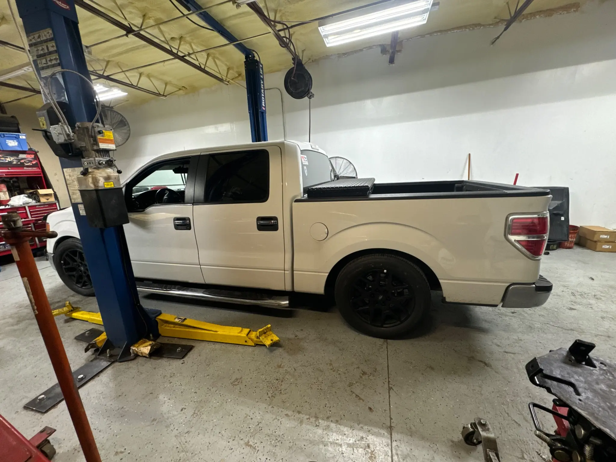 Ford F-150 shop truck side profile in the workshop
